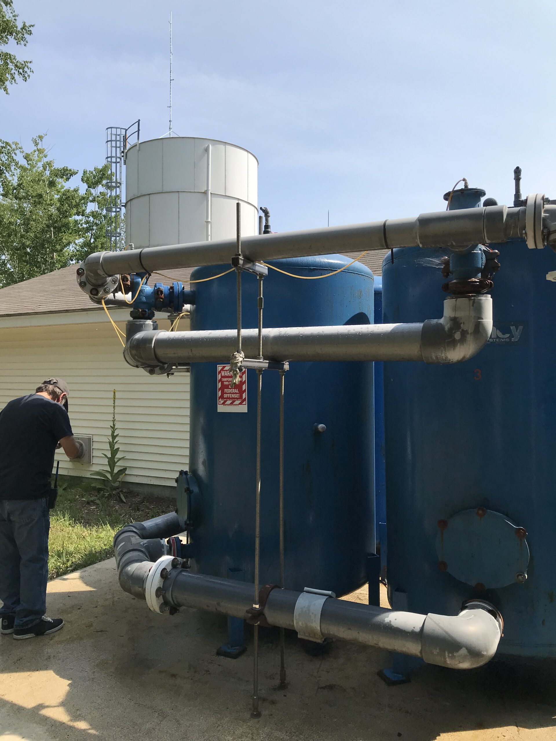 Water operator working beside treatment equipment